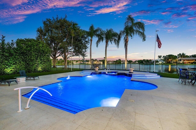 pool at dusk with a patio, fence, and a fenced in pool