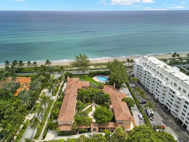 bird's eye view with a water view and a beach view