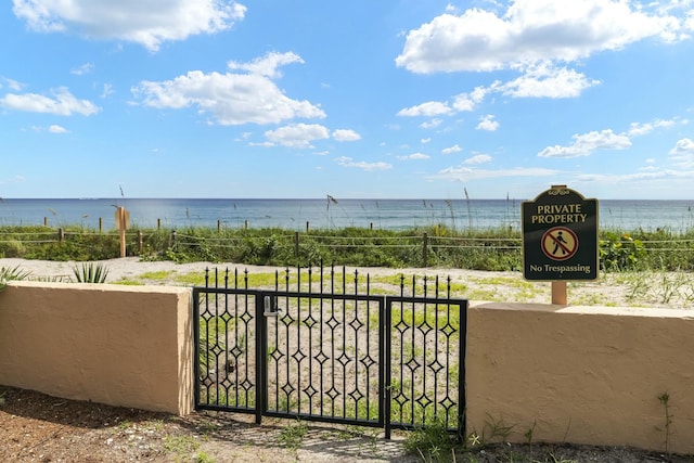 view of water feature with a gate and fence