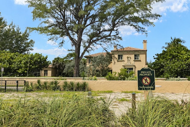 view of home's community featuring fence