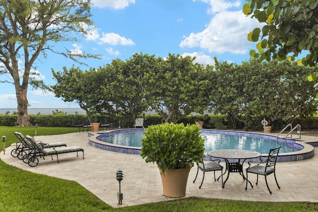 pool featuring a patio and a yard