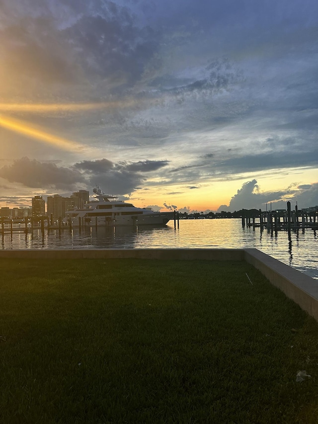 exterior space with a water view and a lawn