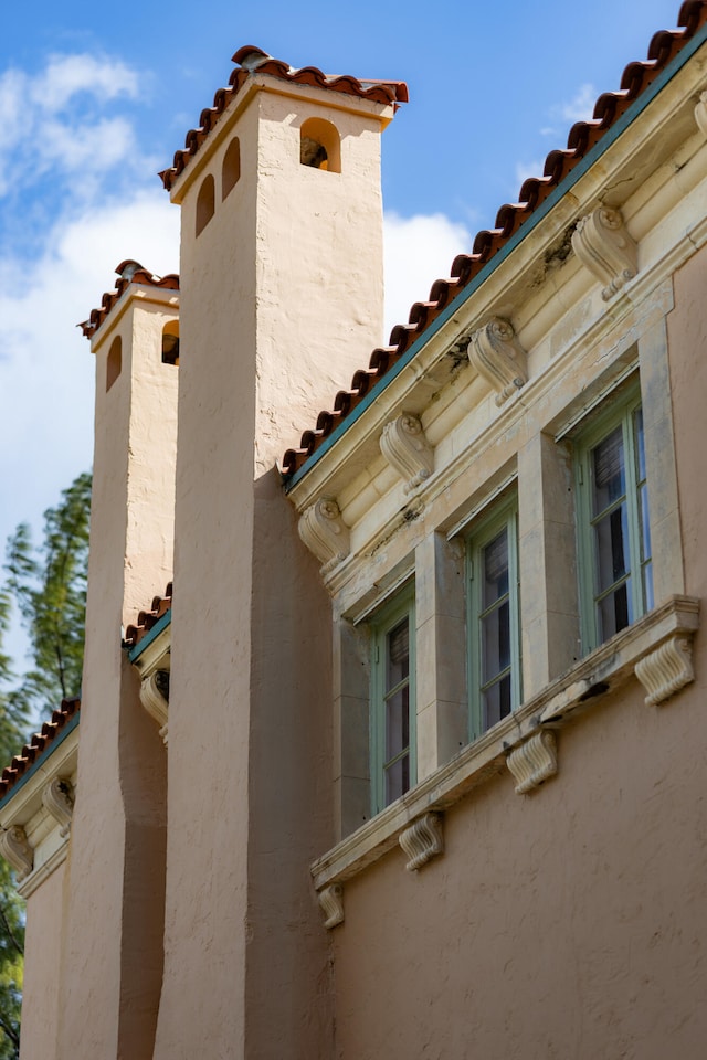 view of side of home featuring a tiled roof