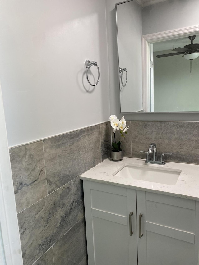 bathroom featuring vanity, tile walls, and ceiling fan