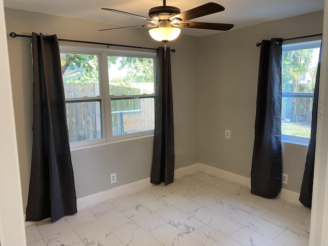 spare room with plenty of natural light and ceiling fan