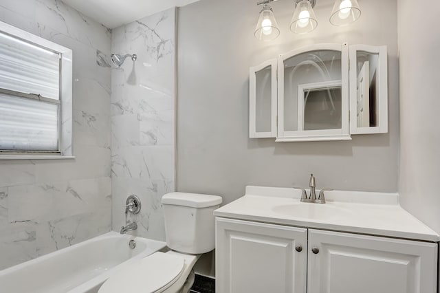 full bathroom featuring vanity, tiled shower / bath combo, and toilet