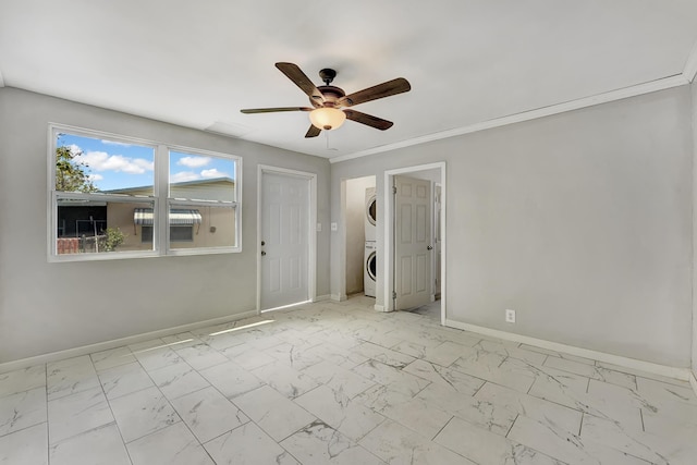 unfurnished bedroom featuring ceiling fan and stacked washer / drying machine