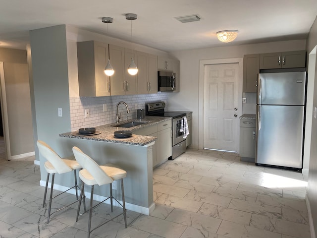 kitchen featuring light stone countertops, tasteful backsplash, stainless steel appliances, light tile floors, and sink