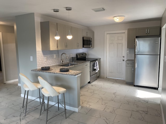 kitchen featuring sink, gray cabinets, stainless steel appliances, and stone counters