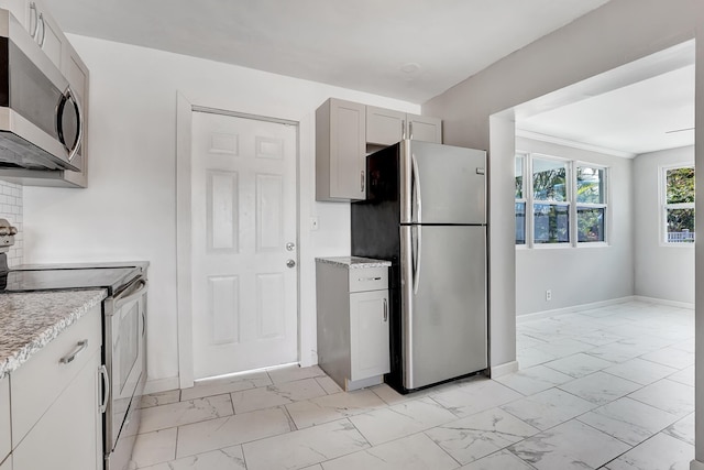 kitchen with stainless steel appliances, gray cabinets, and backsplash