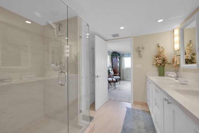 bathroom featuring vanity and an enclosed shower