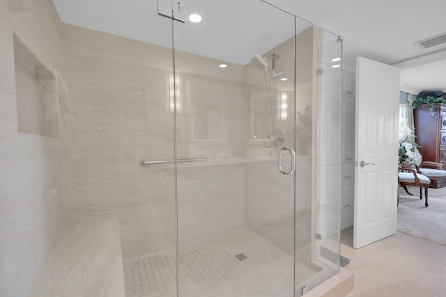 bathroom featuring a shower with shower door