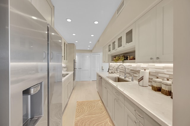 kitchen with white cabinetry, sink, and appliances with stainless steel finishes