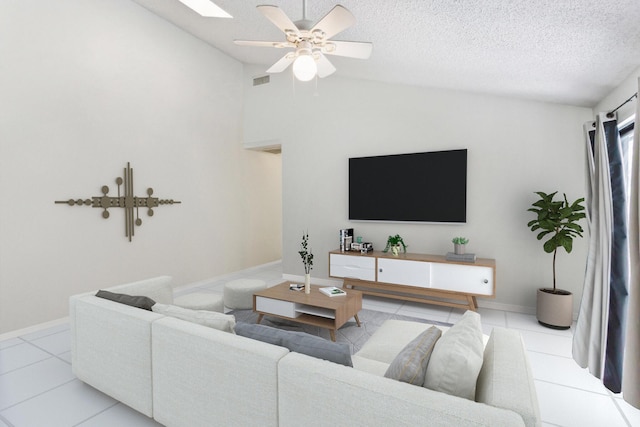 tiled living room with a textured ceiling, ceiling fan, and lofted ceiling