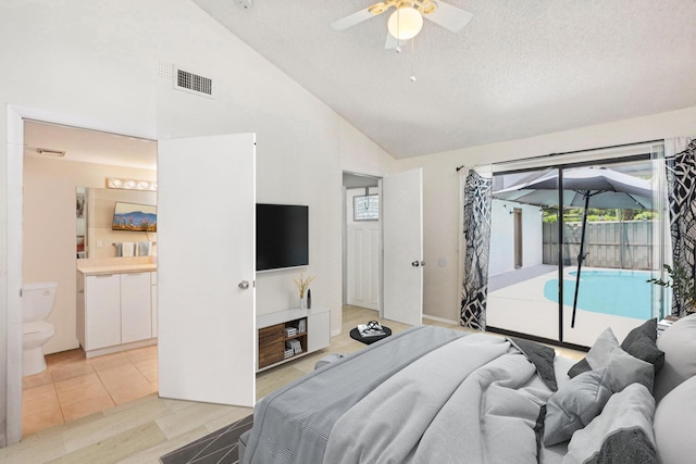 tiled bedroom featuring access to exterior, ensuite bathroom, a textured ceiling, ceiling fan, and high vaulted ceiling