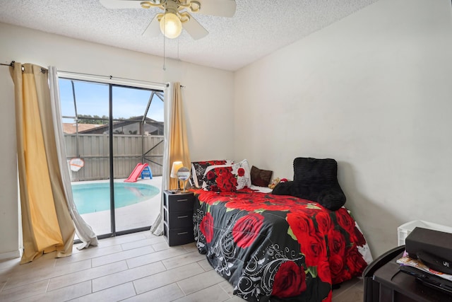 bedroom with access to exterior, ceiling fan, and a textured ceiling