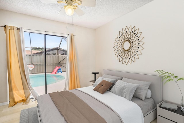 bedroom featuring ceiling fan, access to exterior, wood-type flooring, and a textured ceiling