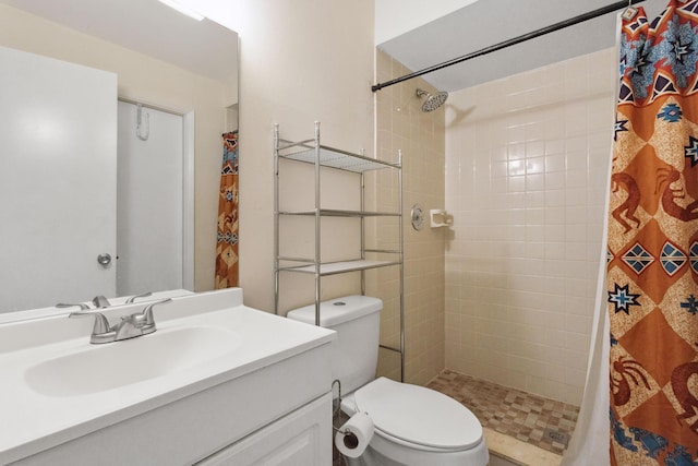 bathroom featuring vanity, toilet, and walk in shower