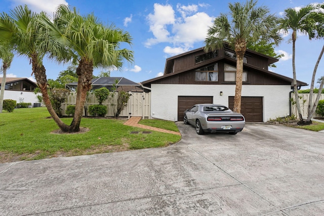 view of front of home with a front lawn and a garage