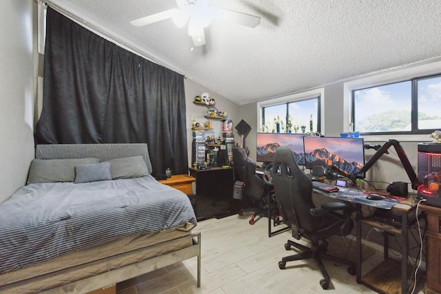 bedroom featuring ceiling fan, a textured ceiling, and vaulted ceiling