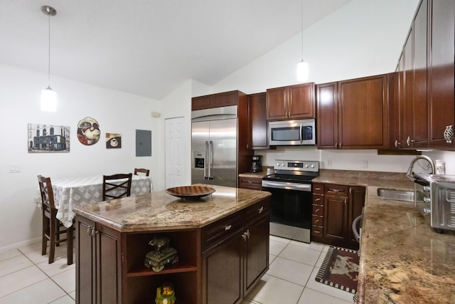 kitchen with a center island, sink, hanging light fixtures, light tile patterned floors, and stainless steel appliances