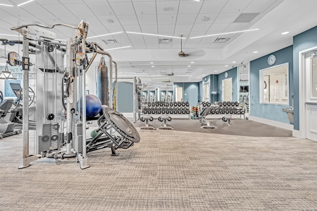 gym featuring a paneled ceiling, carpet, visible vents, and baseboards