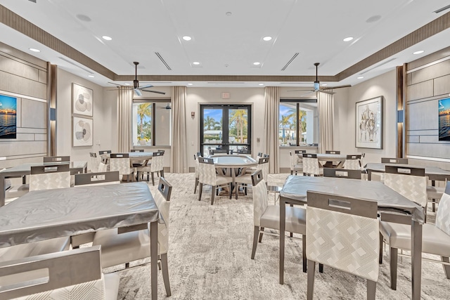 dining area with ceiling fan, french doors, a raised ceiling, and recessed lighting