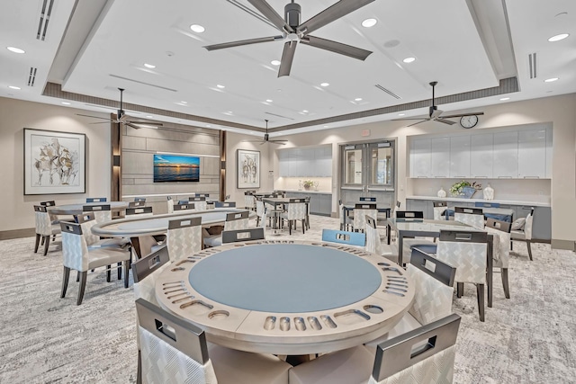 rec room with a tray ceiling, a ceiling fan, and recessed lighting