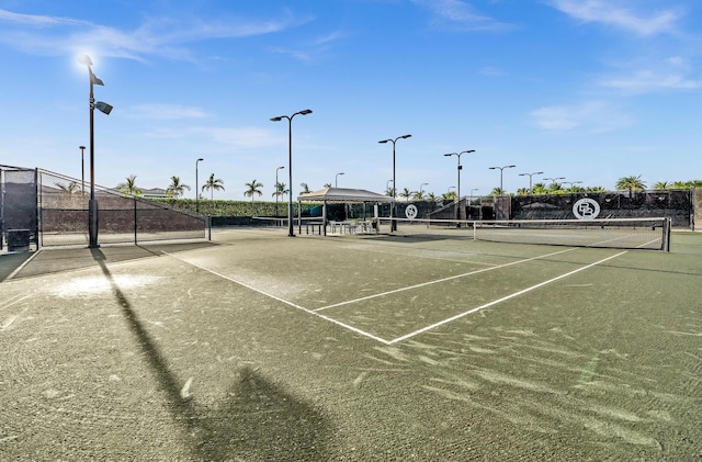 view of tennis court featuring fence