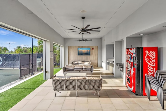 view of patio / terrace featuring fence, outdoor lounge area, and a ceiling fan