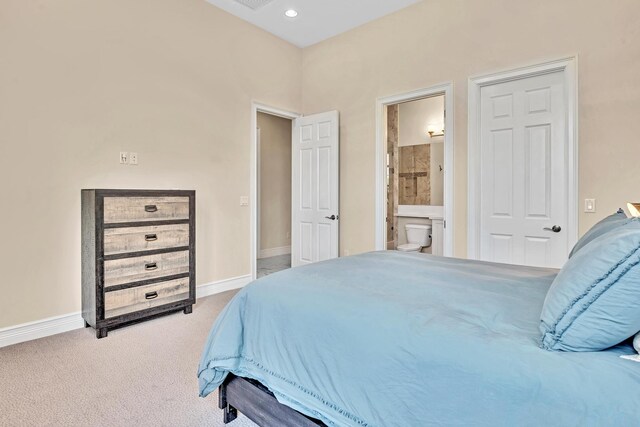 carpeted bedroom featuring ensuite bathroom