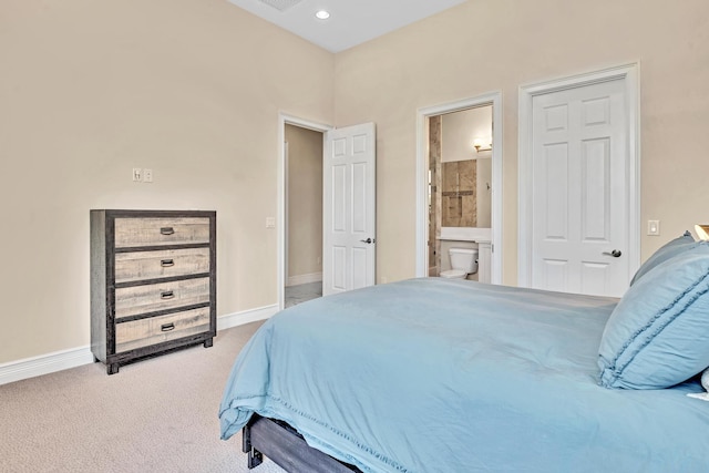 carpeted bedroom with ensuite bath, baseboards, and recessed lighting