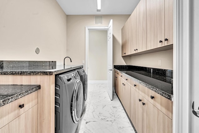 clothes washing area with marble finish floor, visible vents, cabinet space, washing machine and dryer, and baseboards