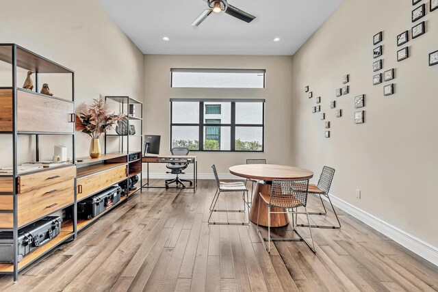 dining room with ceiling fan and light hardwood / wood-style floors