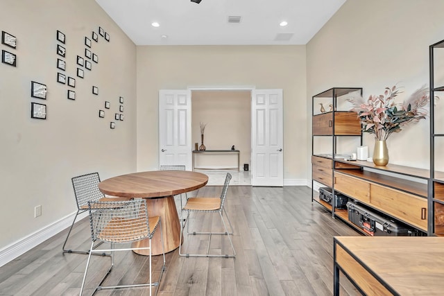 dining room featuring recessed lighting, wood finished floors, visible vents, and baseboards