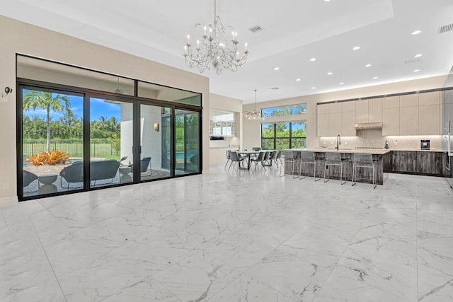 living room featuring an inviting chandelier, visible vents, marble finish floor, and recessed lighting