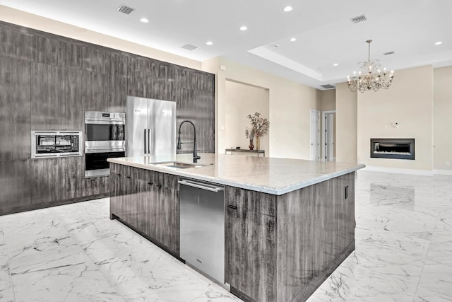 kitchen with visible vents, modern cabinets, appliances with stainless steel finishes, and a sink