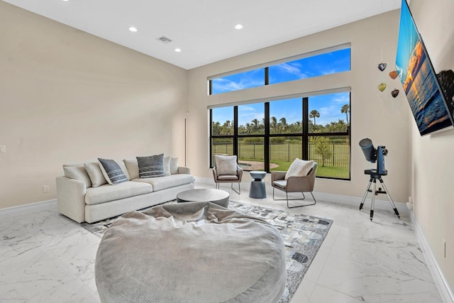 living area featuring marble finish floor, visible vents, baseboards, and recessed lighting