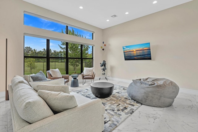 living area with marble finish floor, visible vents, baseboards, and recessed lighting