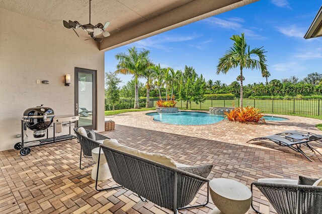 view of pool featuring a patio area, ceiling fan, and pool water feature