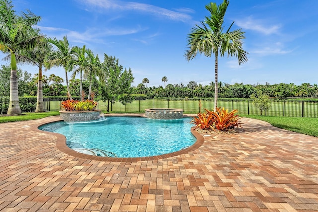 view of swimming pool featuring a pool with connected hot tub, fence, and a patio