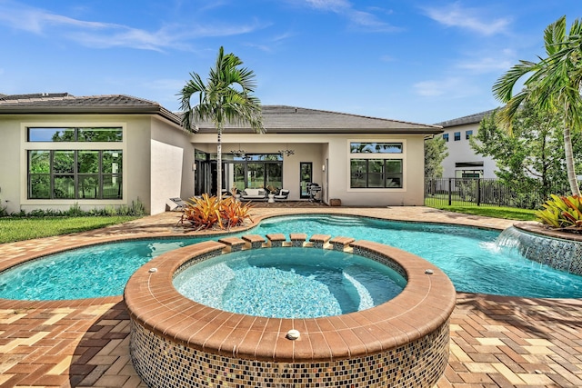 view of pool featuring ceiling fan, a patio, fence, and a pool with connected hot tub