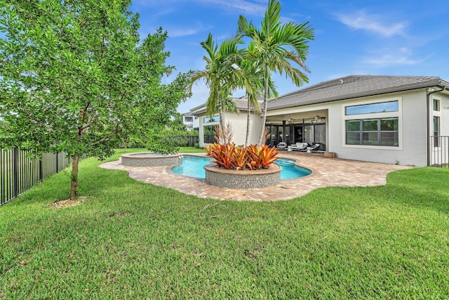 rear view of property featuring a fenced in pool, a fenced backyard, a yard, a patio area, and stucco siding