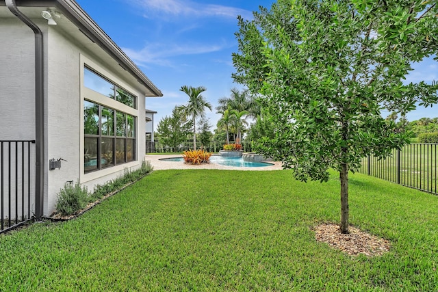 view of yard with pool water feature and a fenced in pool