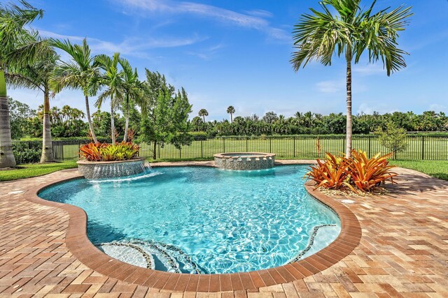 view of swimming pool featuring a patio, an in ground hot tub, and pool water feature