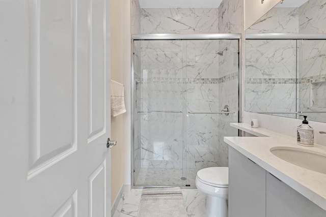 full bath with a marble finish shower, marble finish floor, vanity, and toilet