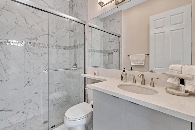 full bathroom featuring toilet, a marble finish shower, and vanity