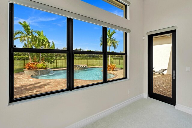 doorway to outside with carpet flooring