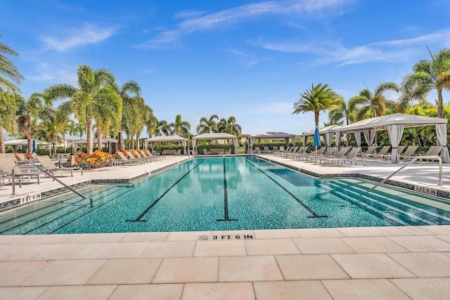 community pool with a gazebo and a patio area