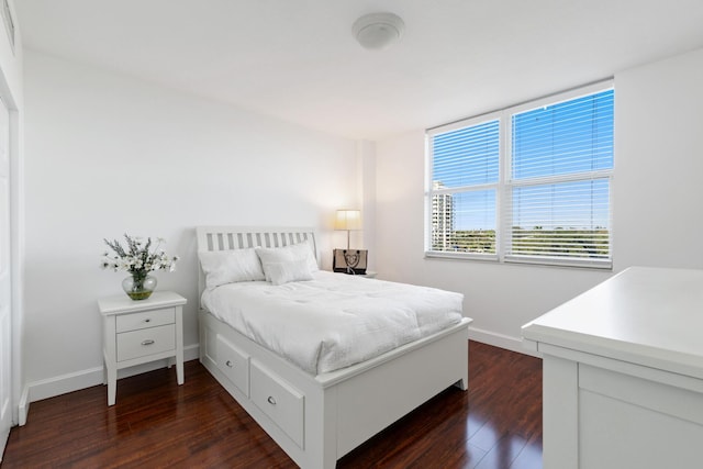 bedroom with dark wood-type flooring